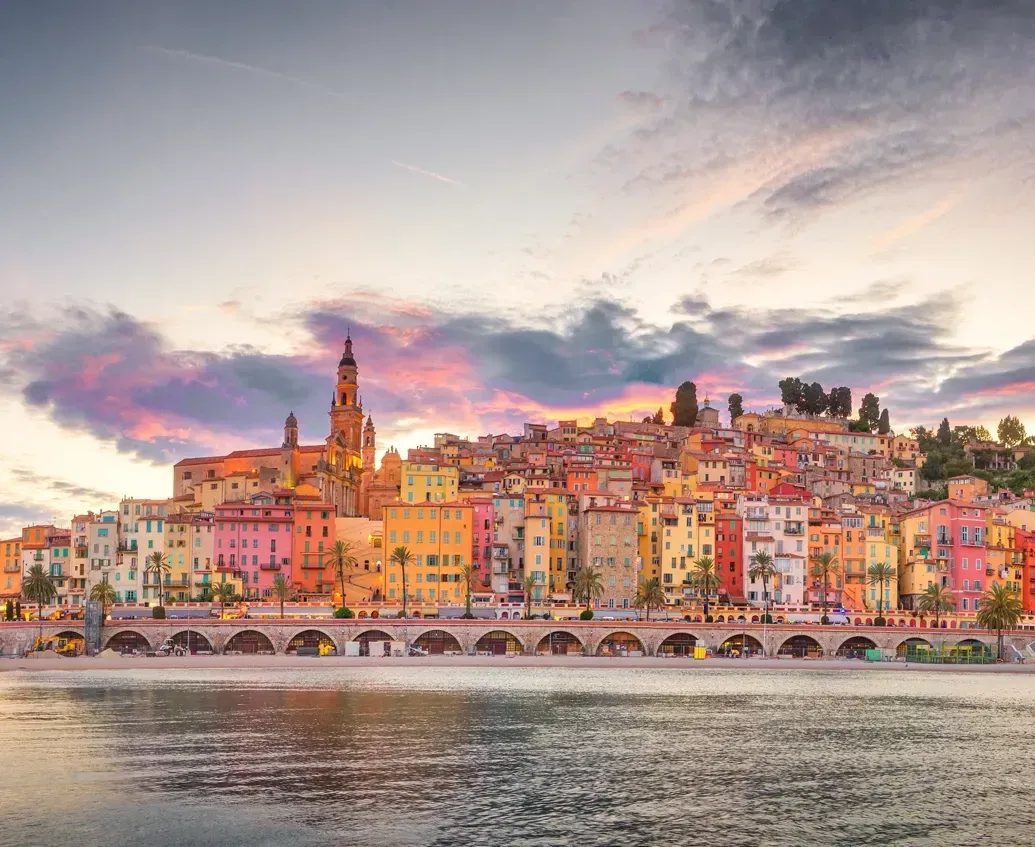 Menton's colourful old town and Saint-Michel basilica seen from the sea